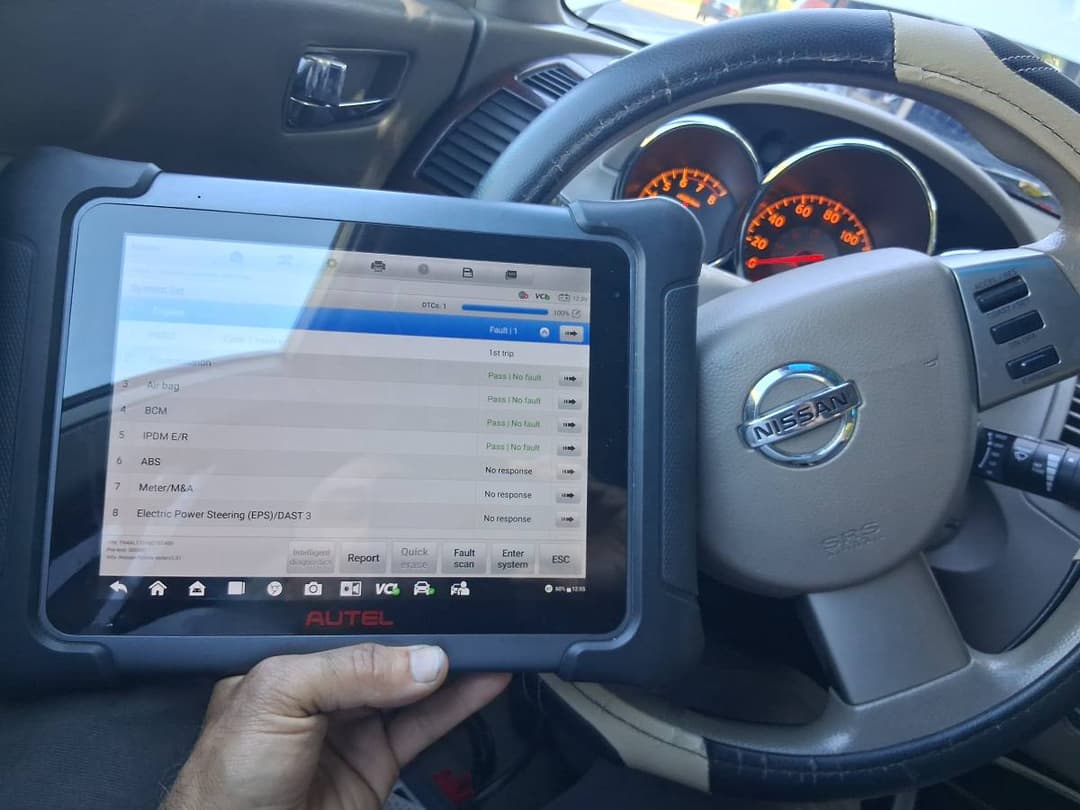 mobile mechanic Running engine diagnostics with OBD-II scanner on-site