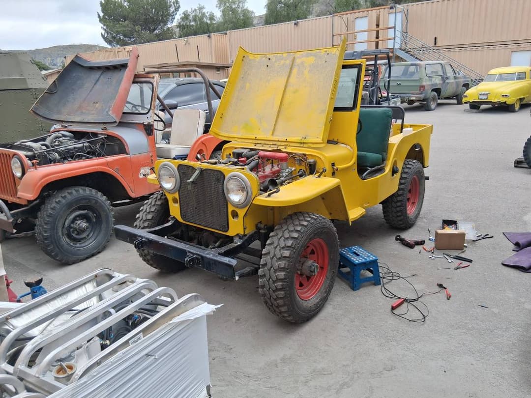 Testing car battery voltage with multimeter during mobile service